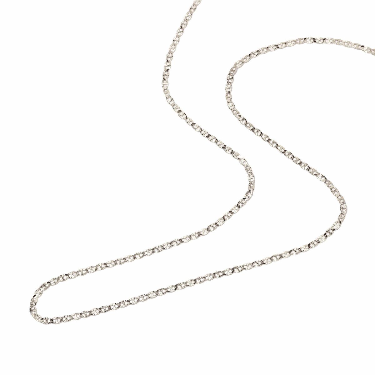 Sterling silver diamond-cut mariner anchor link chain laid in an S-curve on a white background