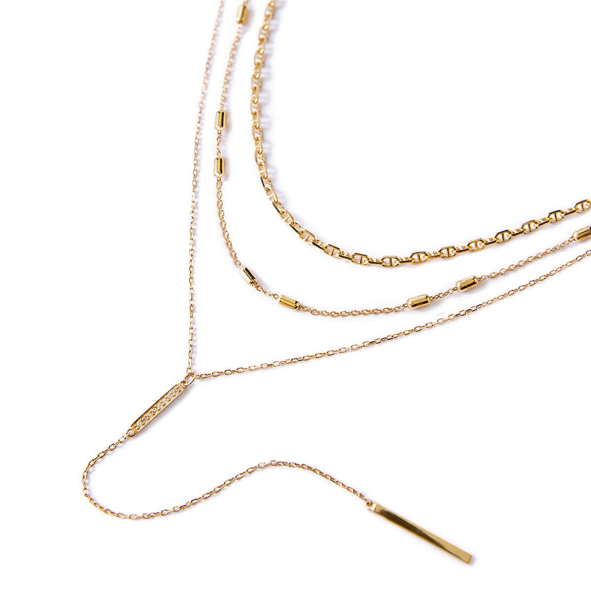 Gold vermeil three-layer lariat necklace set with a pavé bar, laid on a white background