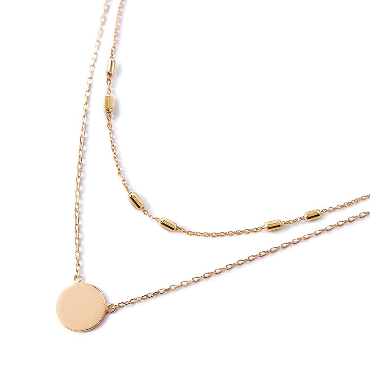 Gold vermeil disc pendant necklace layered with a beaded chain, on a white background