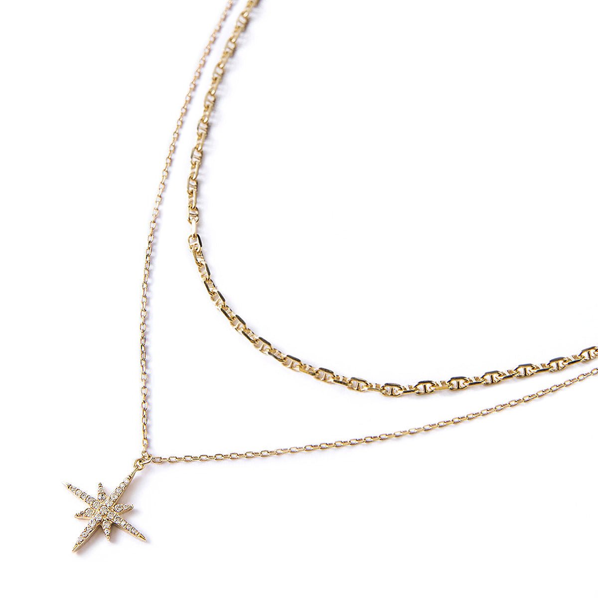 Gold vermeil two-chain layered necklace with a clear crystal starburst pendant, laid on a white background