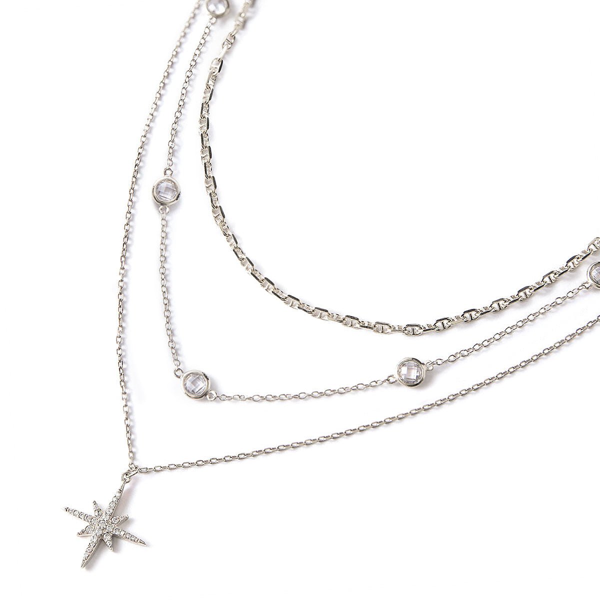 Sterling silver layered trio with a pavé star pendant, Marina chain and clear stones, on a white background