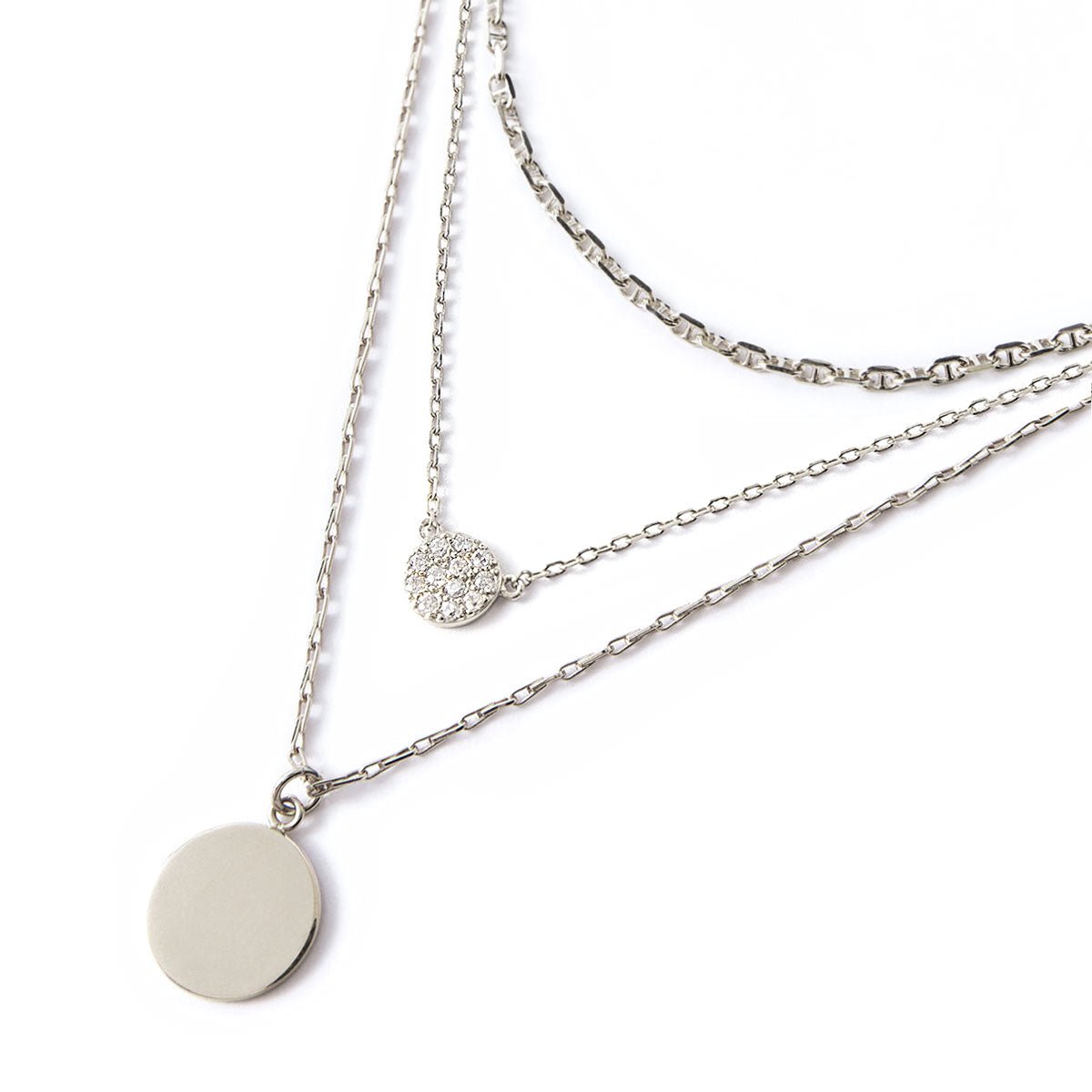 Sterling silver Marina chain, clear crystal disc and plain disc pendant layered trio, on a white background