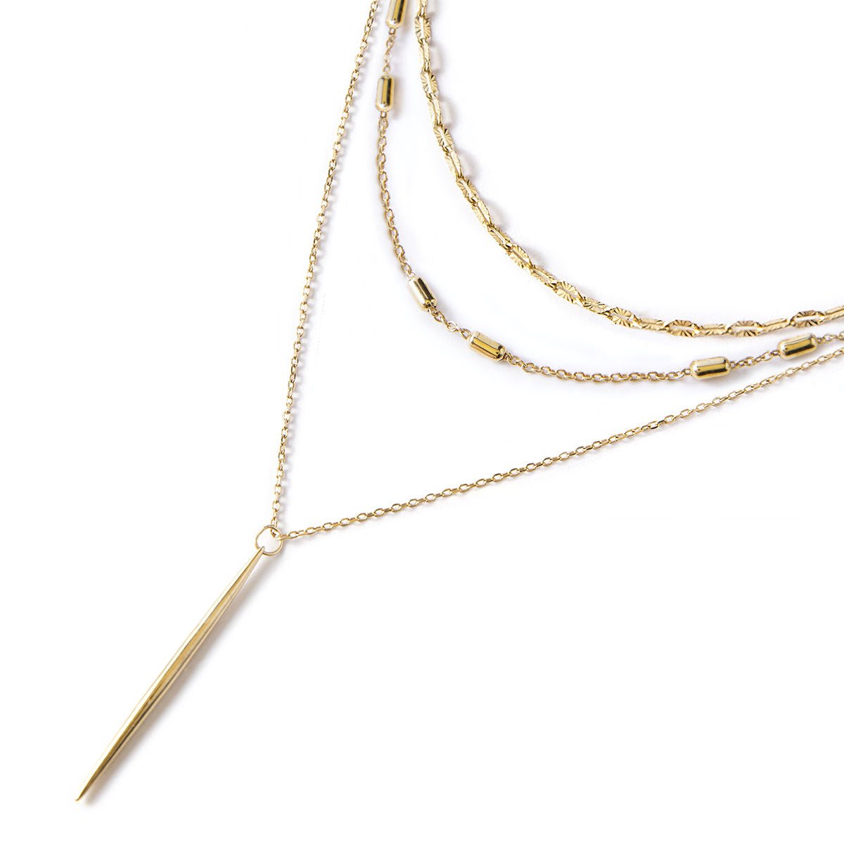 Gold vermeil layered necklace set with patterned chains and a slim needle bar drop, on a white background