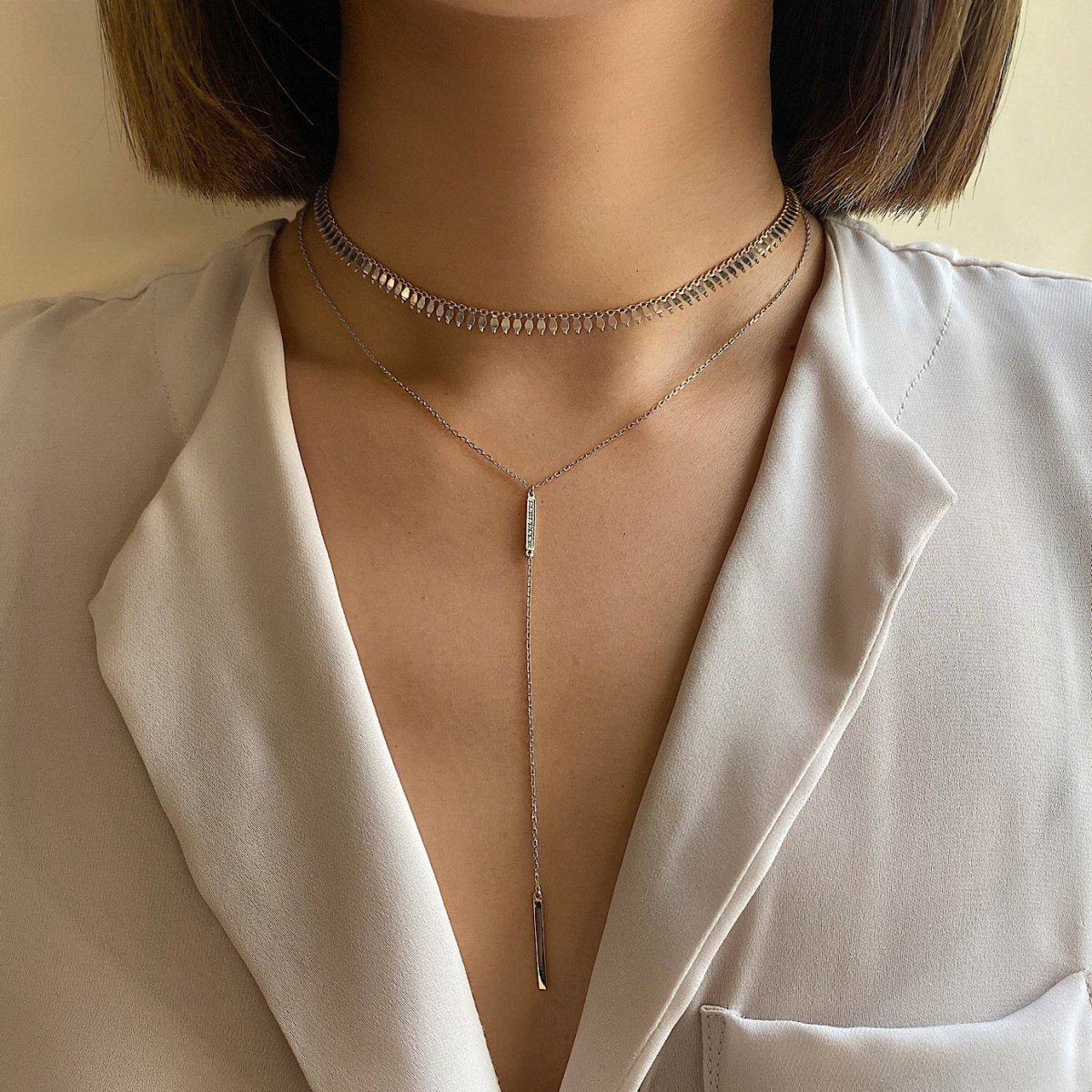 Sterling silver fringe choker layered with a slim lariat bar drop, shown on a model's neckline