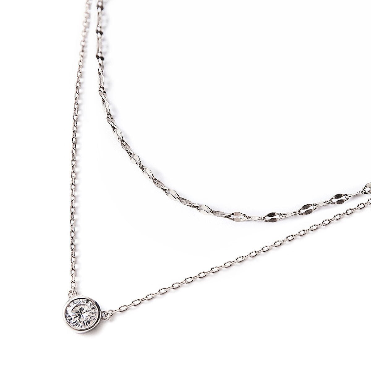 Sterling silver layered necklace duo with a bezel-set round clear solitaire stone, on a white background