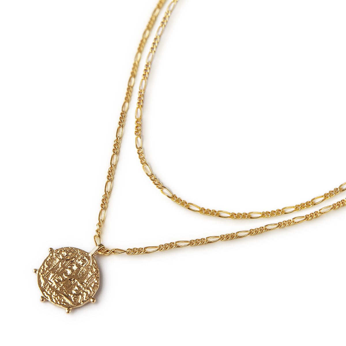 Gold vermeil layered necklace duo with a figaro chain and a textured coin pendant, on a white background
