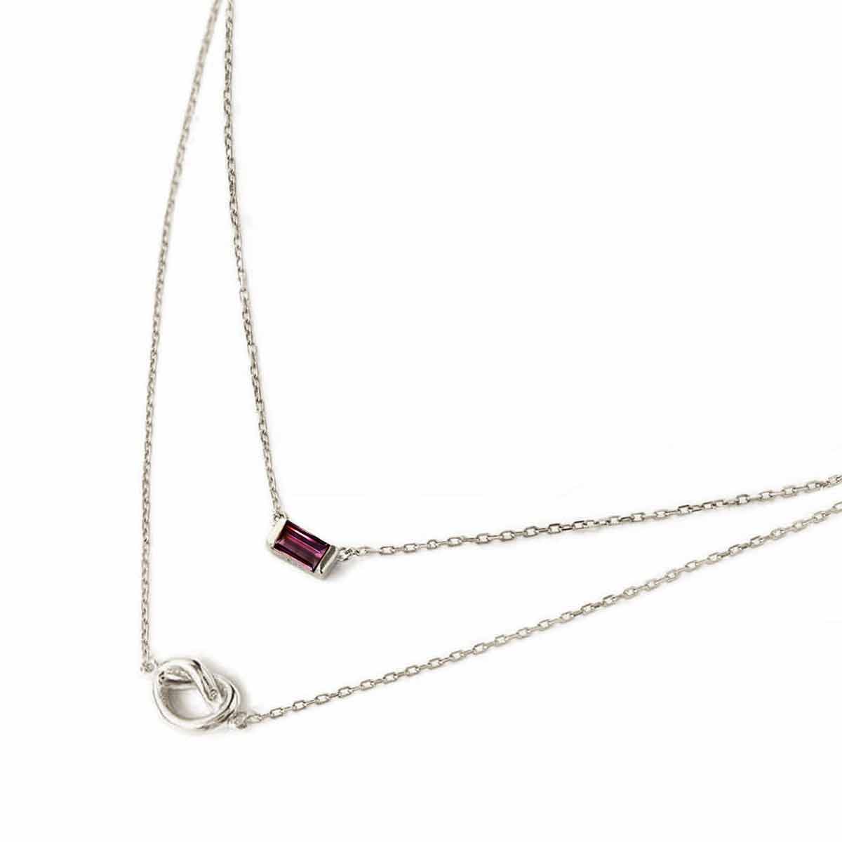 Sterling silver layered duo necklace with a red baguette ruby and a knot, on a white background