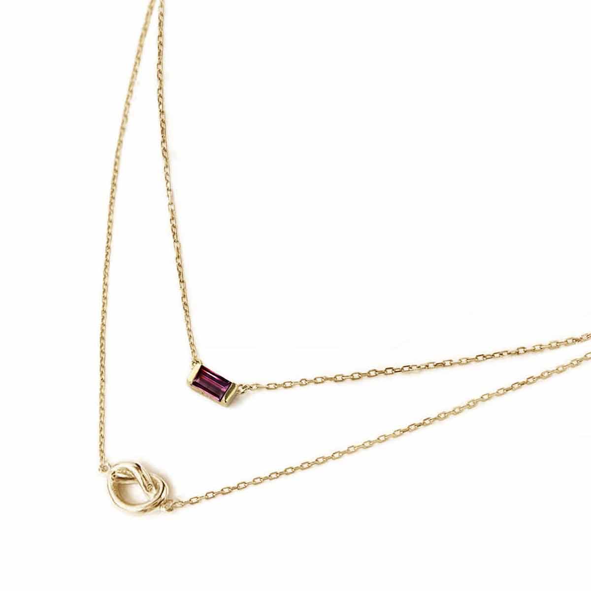 Gold vermeil layered duo necklace with a red baguette ruby and a knot, on a white background