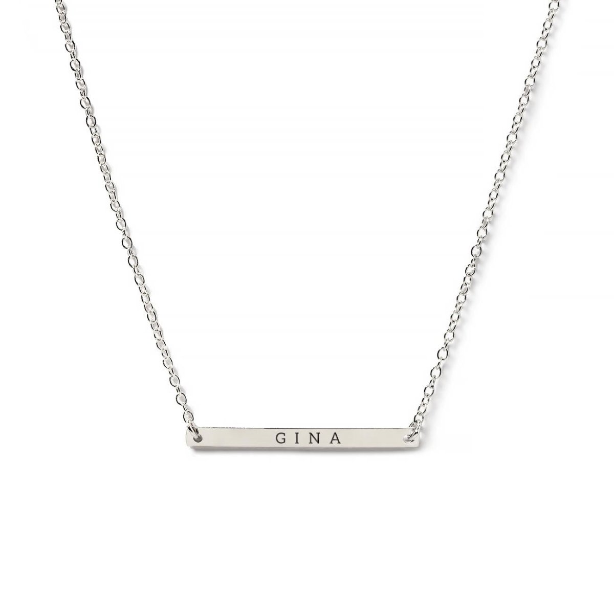 Sterling silver thin bar necklace engraved with a name on a delicate chain, on a white background