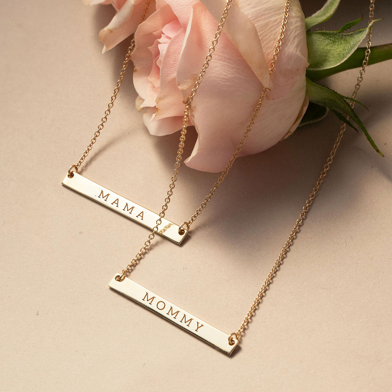 AMYO Gold necklaces with 'MAMA' and 'MOMMY' engraved on them. Perfect personalized gifts for mom.
