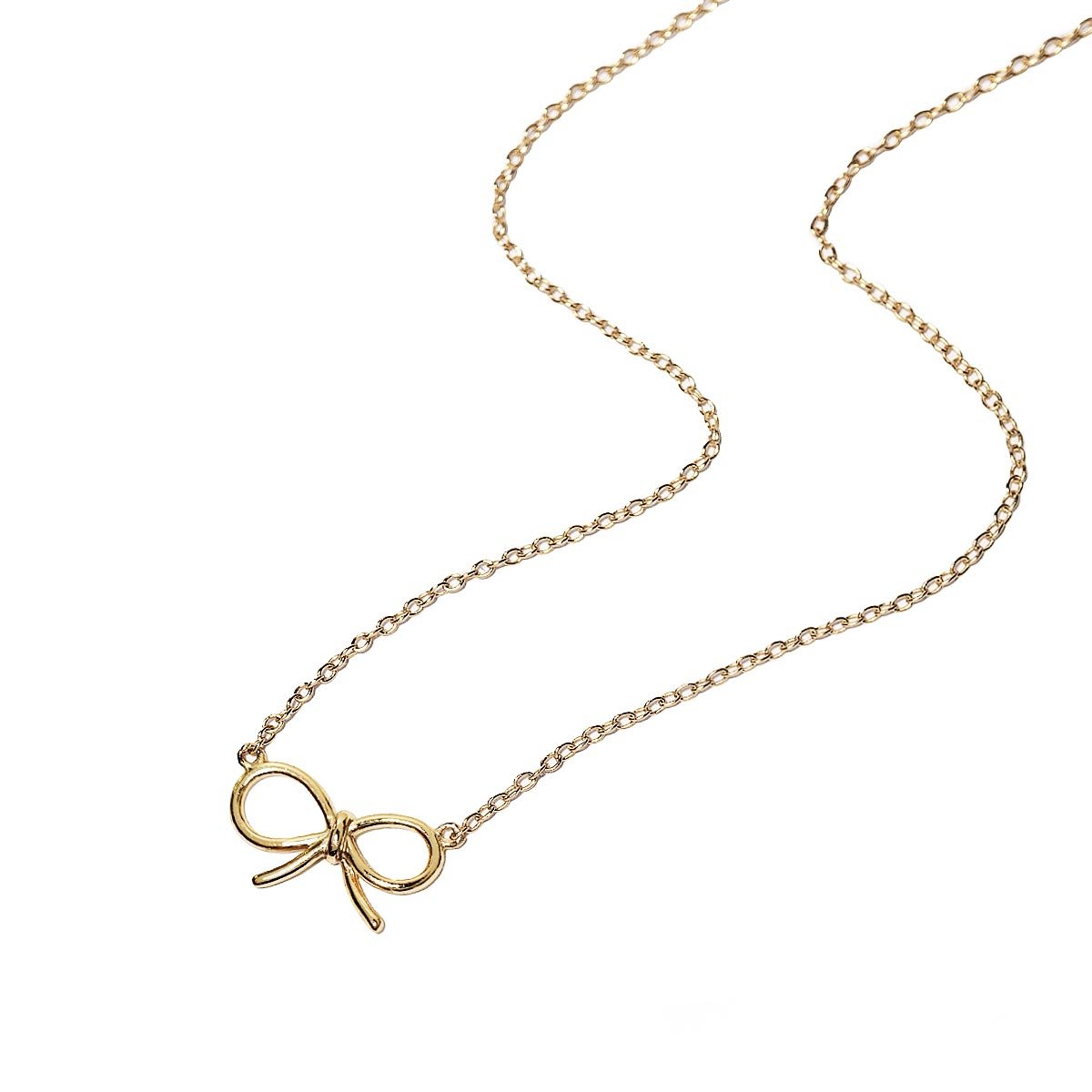 Gold vermeil bow necklace on a thin cable chain, laid out on a white background