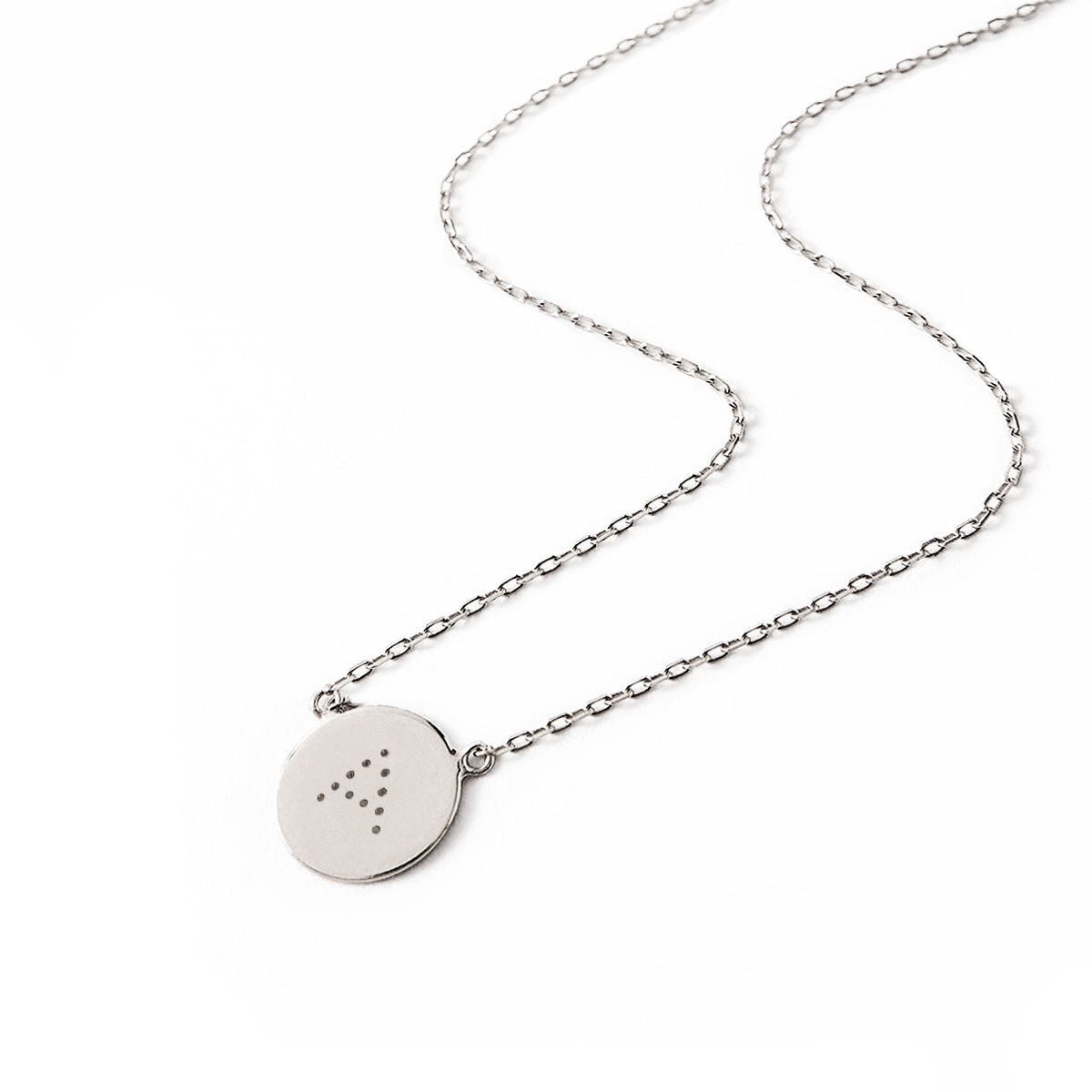 Sterling silver round disc necklace engraved with an initial on a cable chain, on a white background