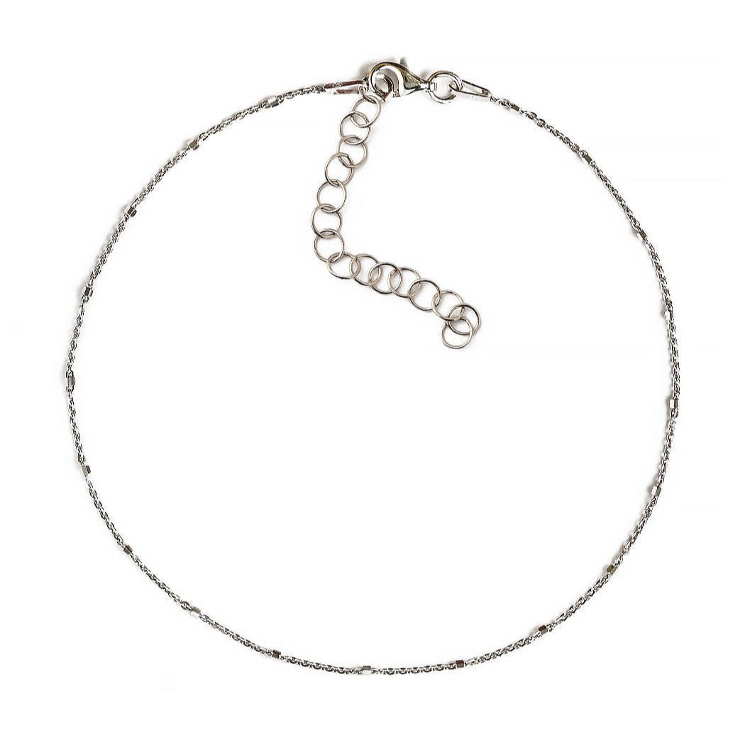 Sterling silver faceted bead chain anklet with an extender and lobster clasp, on a white background