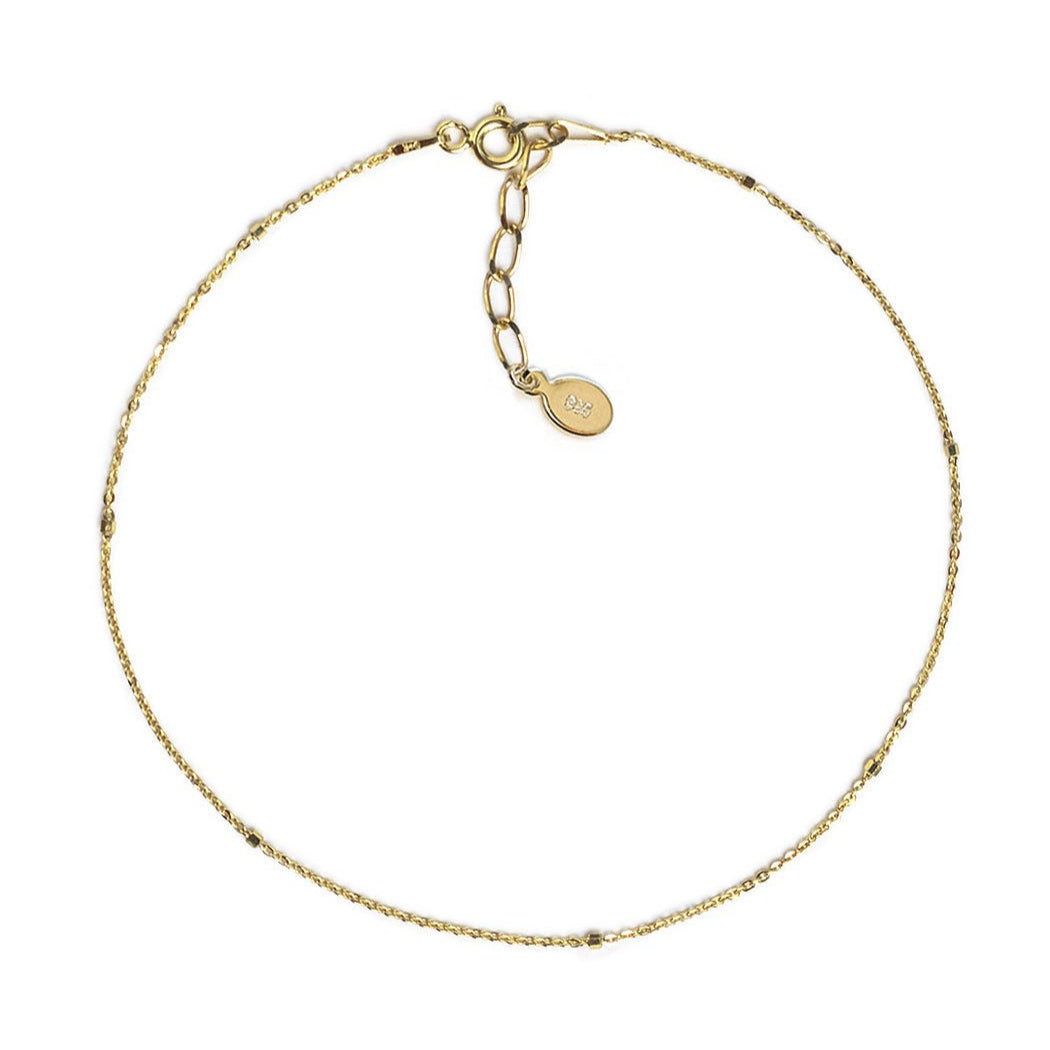 Gold vermeil dainty beaded anklet chain with a spring-ring clasp, laid on a white background