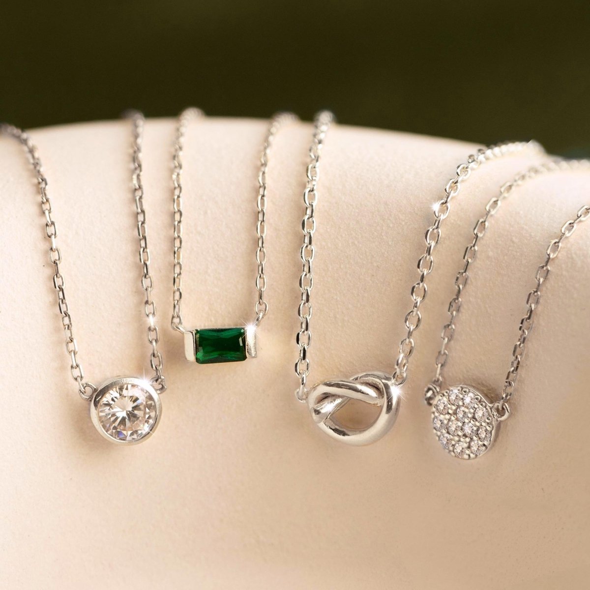 Sterling silver white zirconia pavé disc necklace shown beside other pendant styles