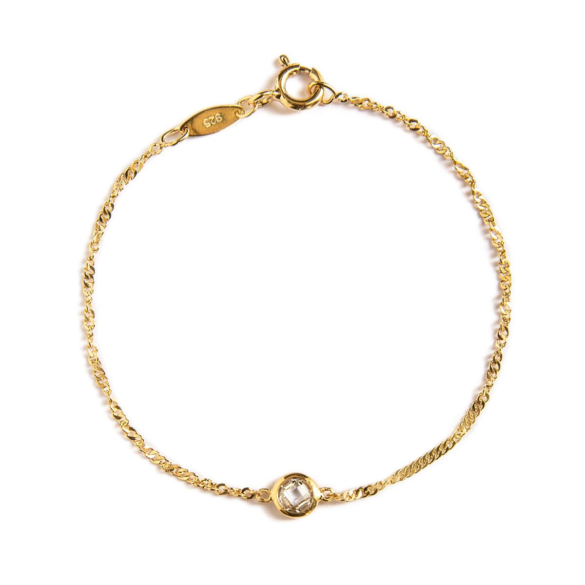 Gold vermeil Singapore chain bracelet with a round clear bezel stone, on a white background