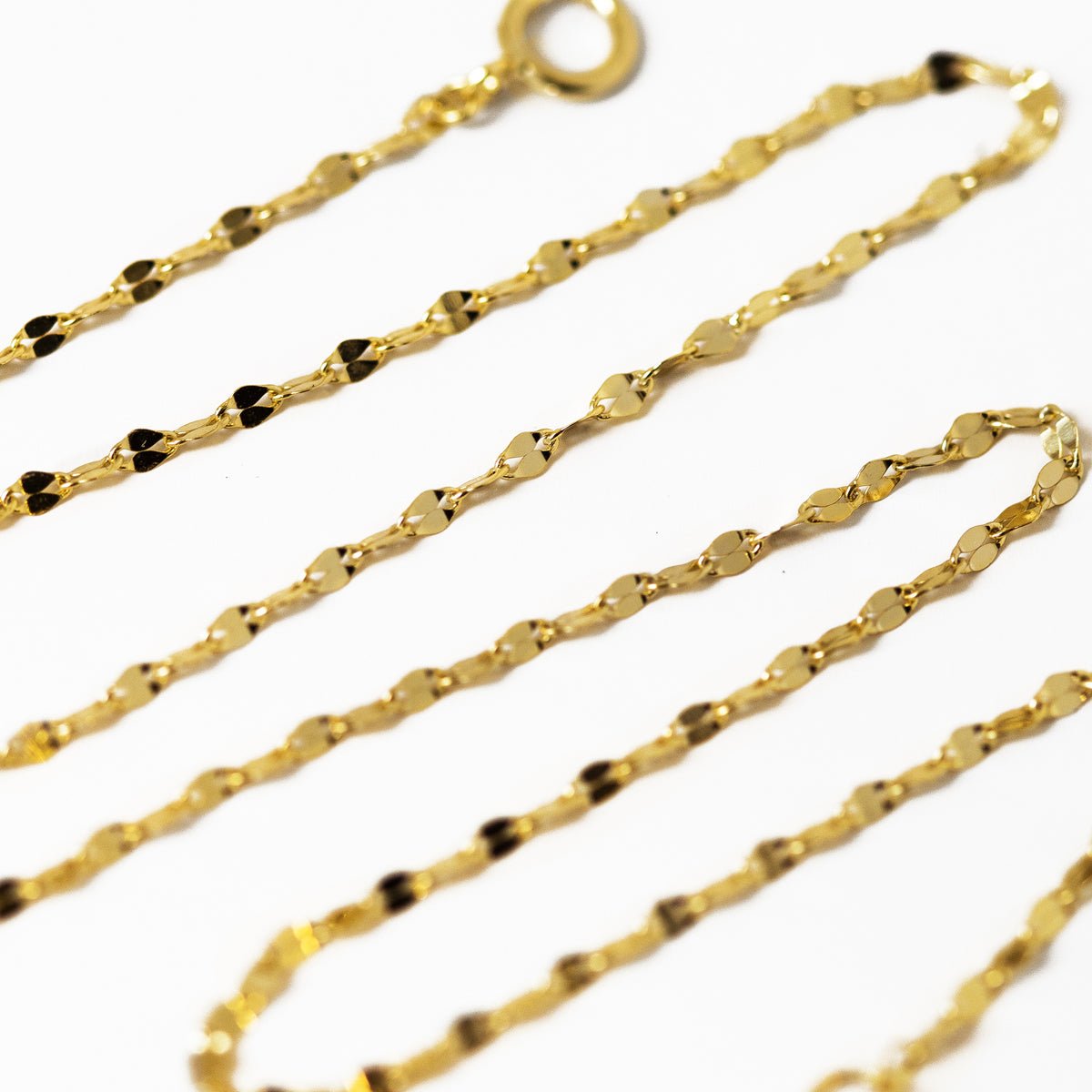 Gold vermeil layered bracelet set with a textured chain and spring-ring clasp, close-up detail