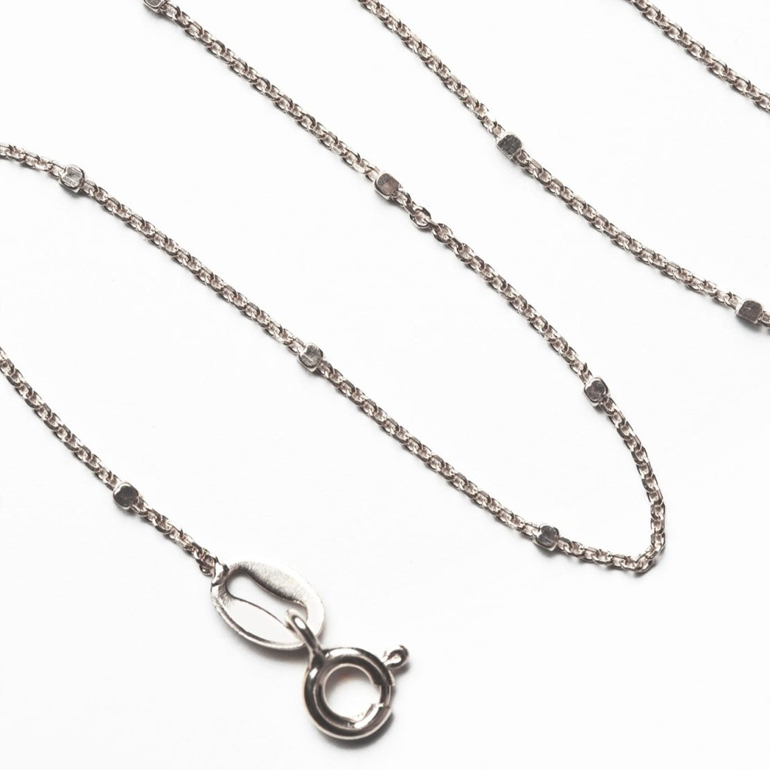 Sterling silver dainty beaded anklet chain, close-up detail of the links and spring-ring clasp