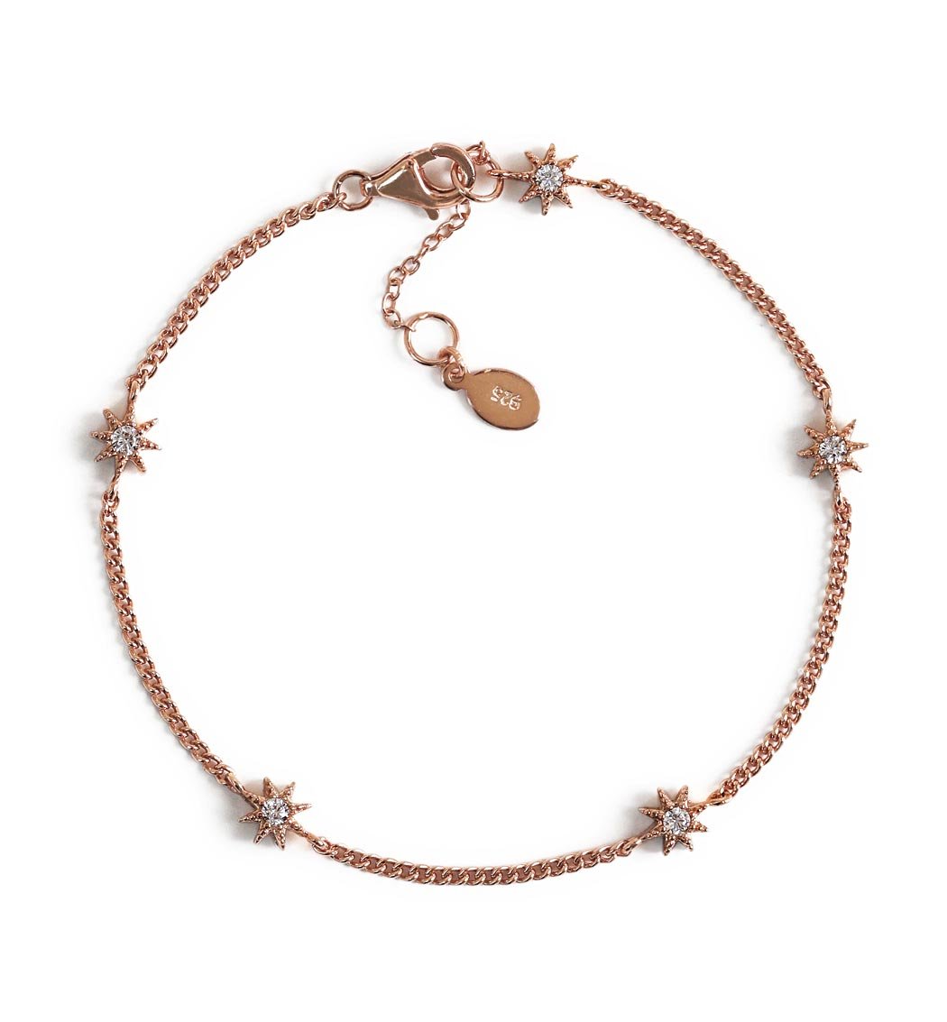 Rose gold vermeil curb chain bracelet with pavé star stations and a lobster clasp, on a white background