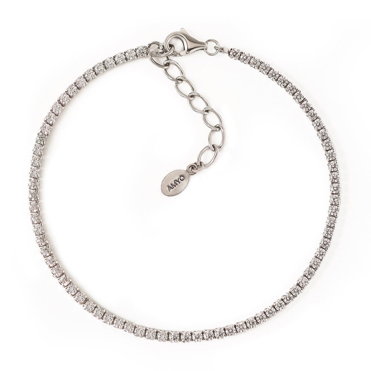 Sterling silver thin tennis bracelet set with white zirconia, lobster clasp and chain extender, on a white background