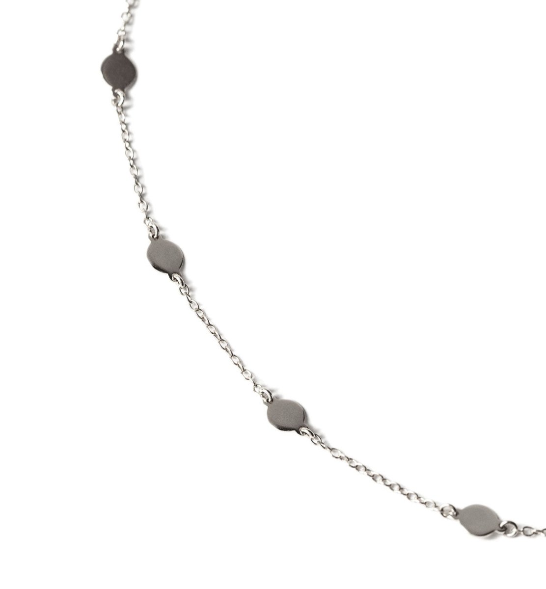 Sterling silver round disc station bracelet draped, close-up detail of discs and chain