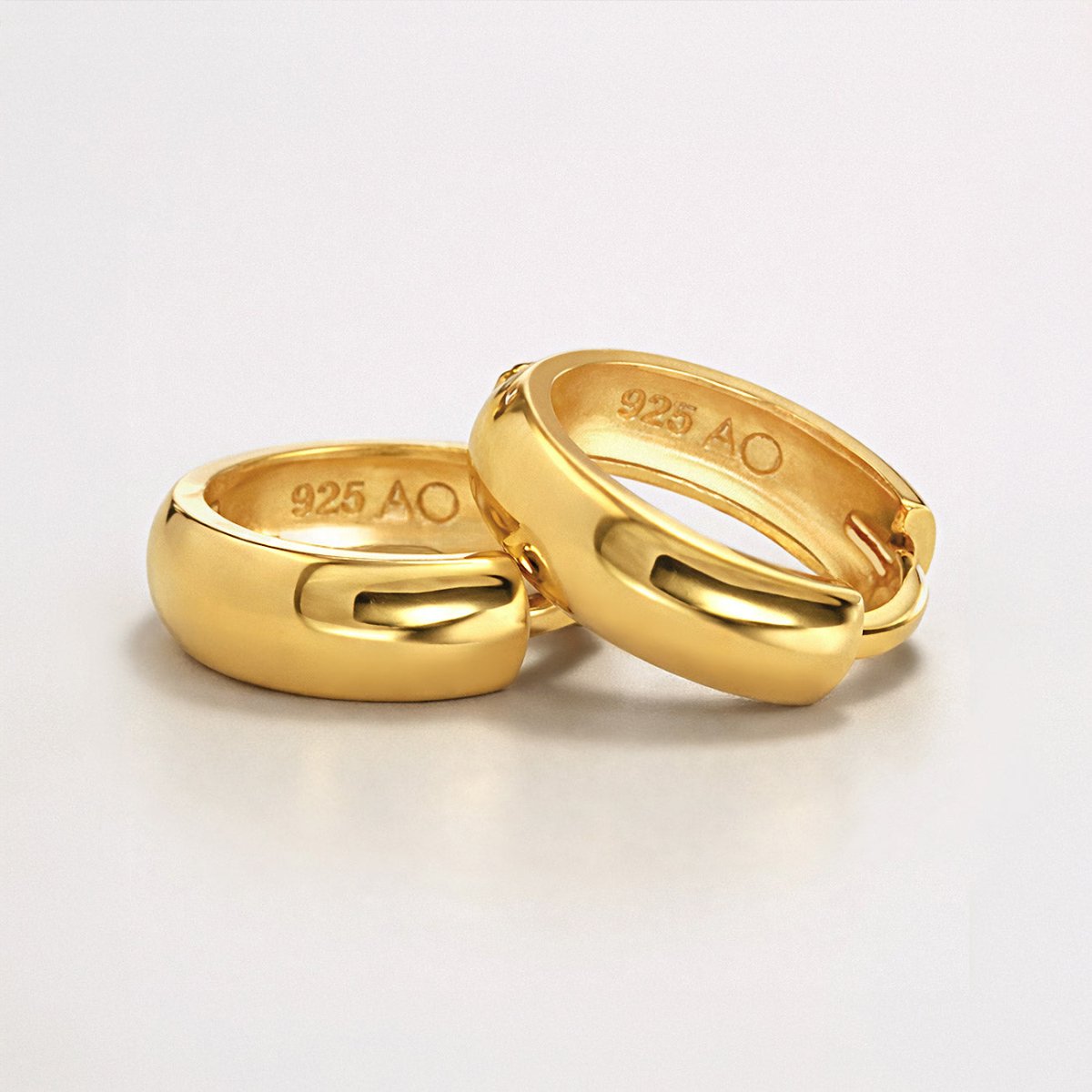 Gold vermeil chunky huggie hoops, close-up detail showing the inner 925 AO hallmark