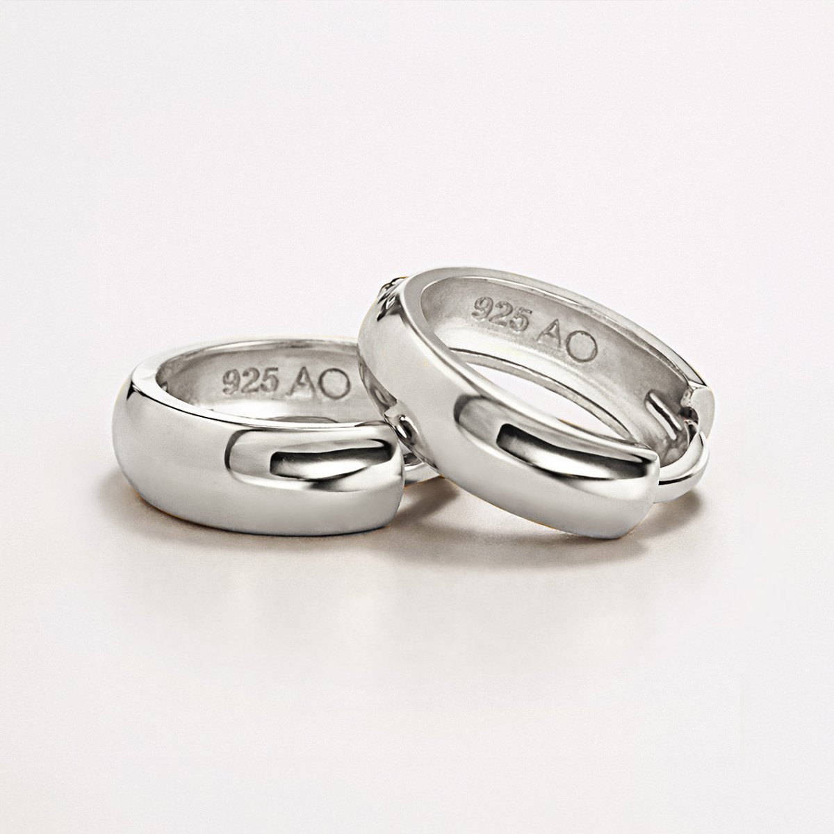 Sterling silver chunky huggie hoops, close-up detail showing the inner 925 AO hallmark