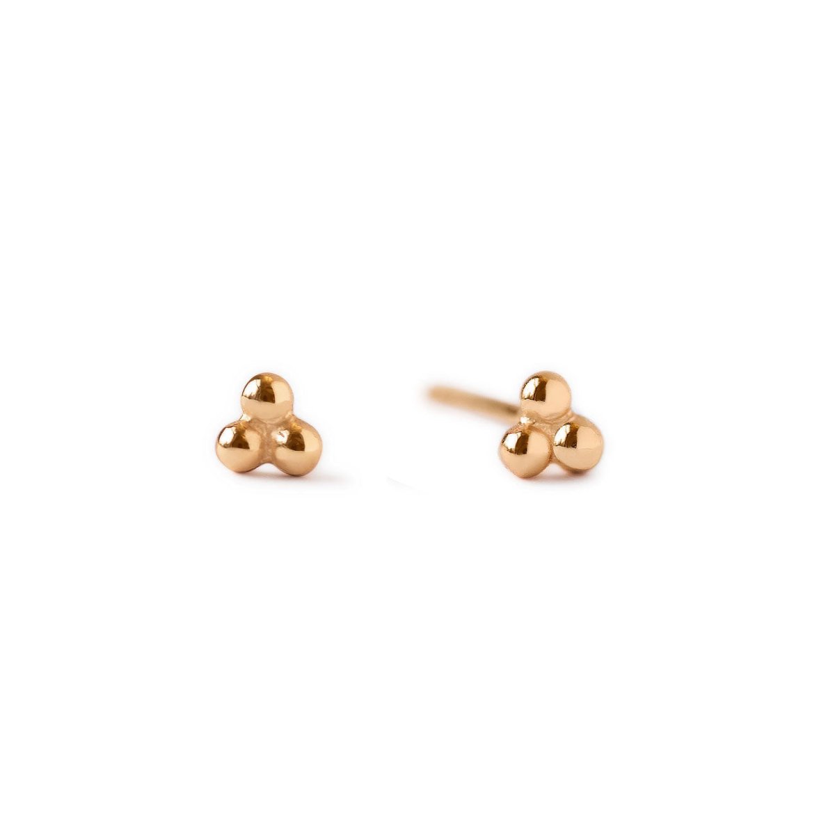 Pair of 14K rose gold tiny three-ball cluster studs, front and side angle, on a white background