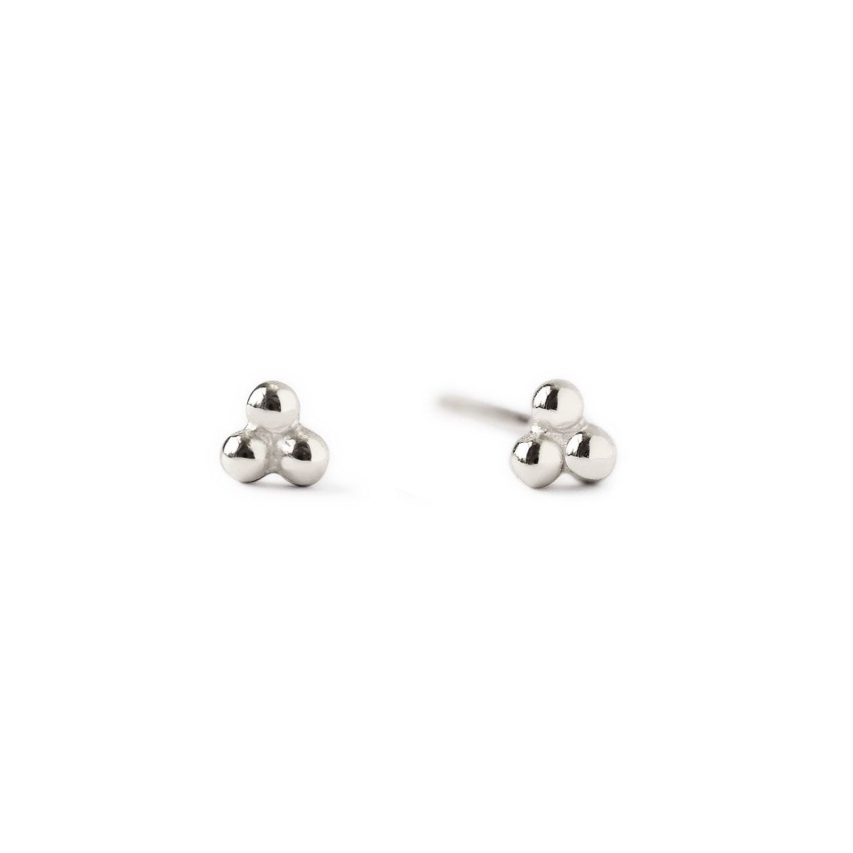 Pair of 14K white gold tiny three-ball cluster studs, front and side angle, on a white background