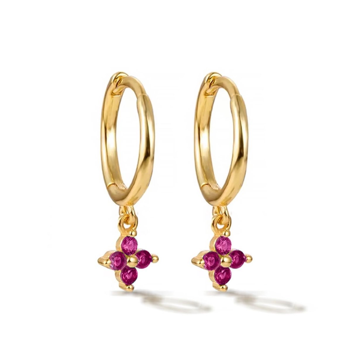 Pair of gold vermeil Flor huggie hoops with a pink ruby four-stone flower, on a white background