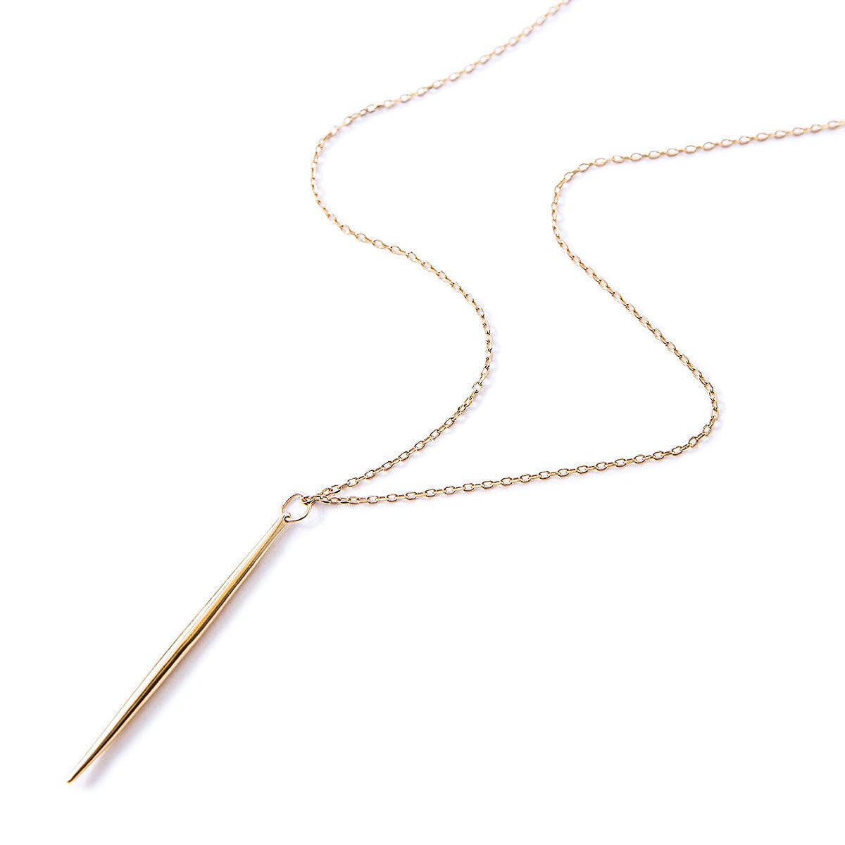 Gold vermeil needle necklace with a slim spike bar pendant on a thin chain, on a white background