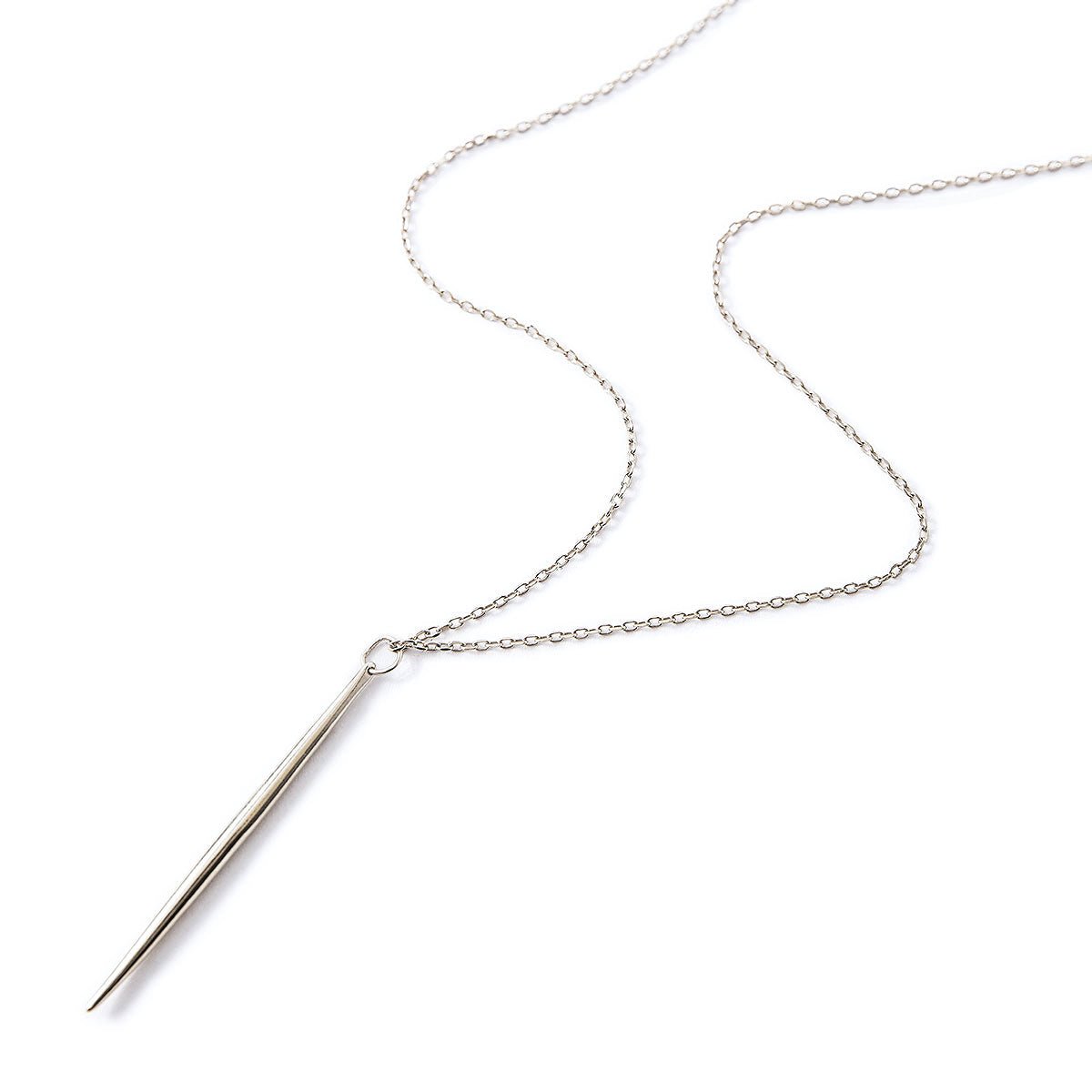 Sterling silver needle necklace with a slim spike bar pendant on a thin chain, on a white background