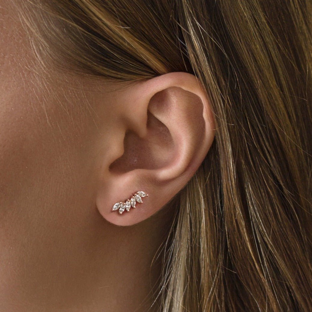 Rose gold vermeil climber earring with white zirconia marquise stones, shown on a model's lobe