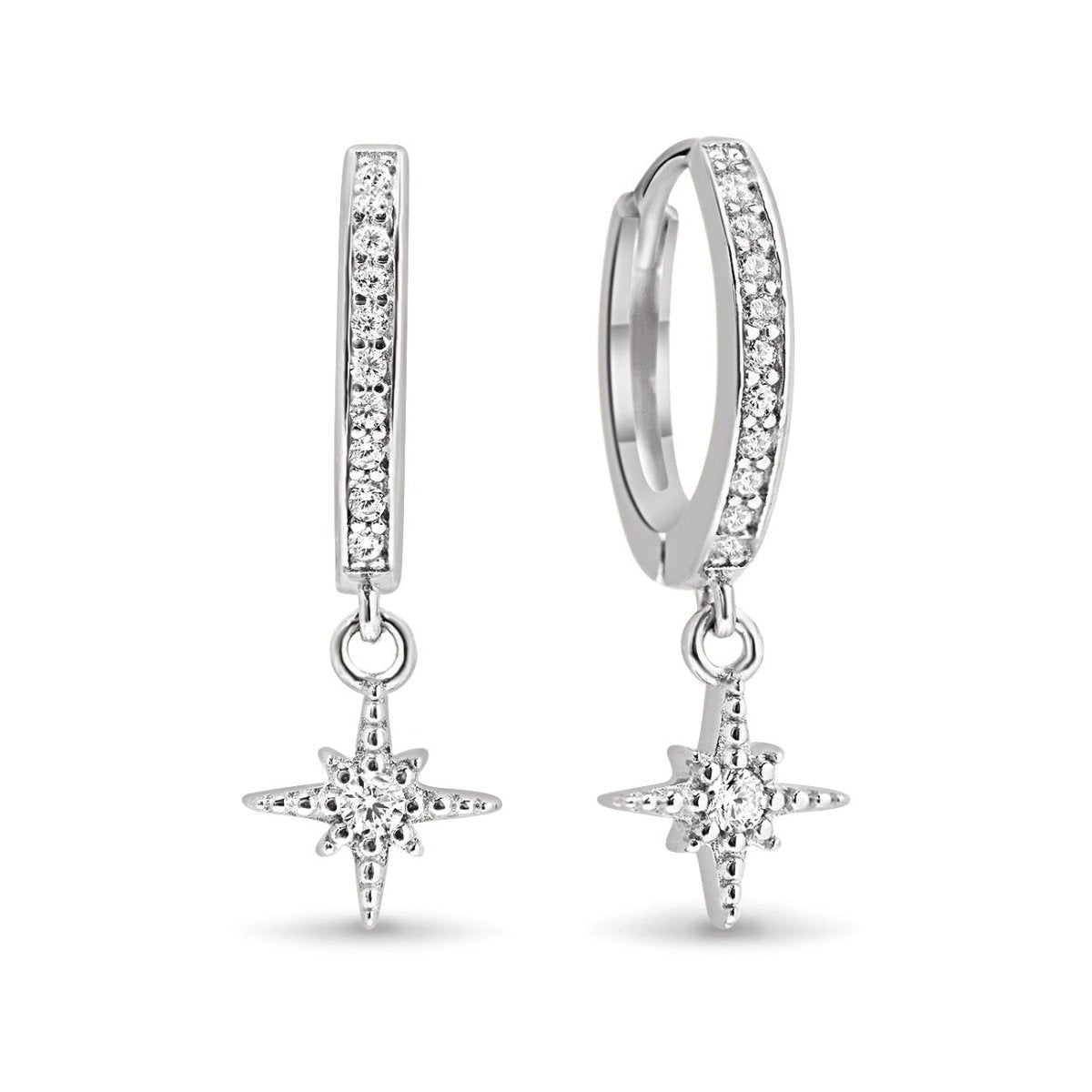 Sterling silver pave huggie hoops with a single white zirconia mini starburst drop, on a white background