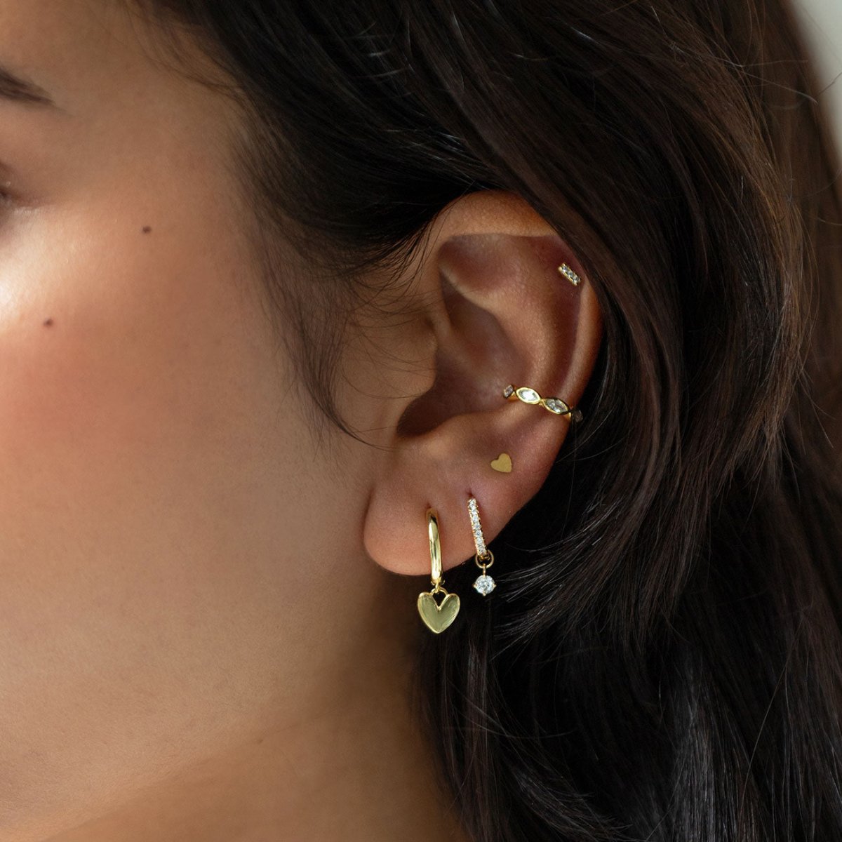 Gold vermeil pavé bar flat back stud with white zirconia, shown on a model's ear stack
