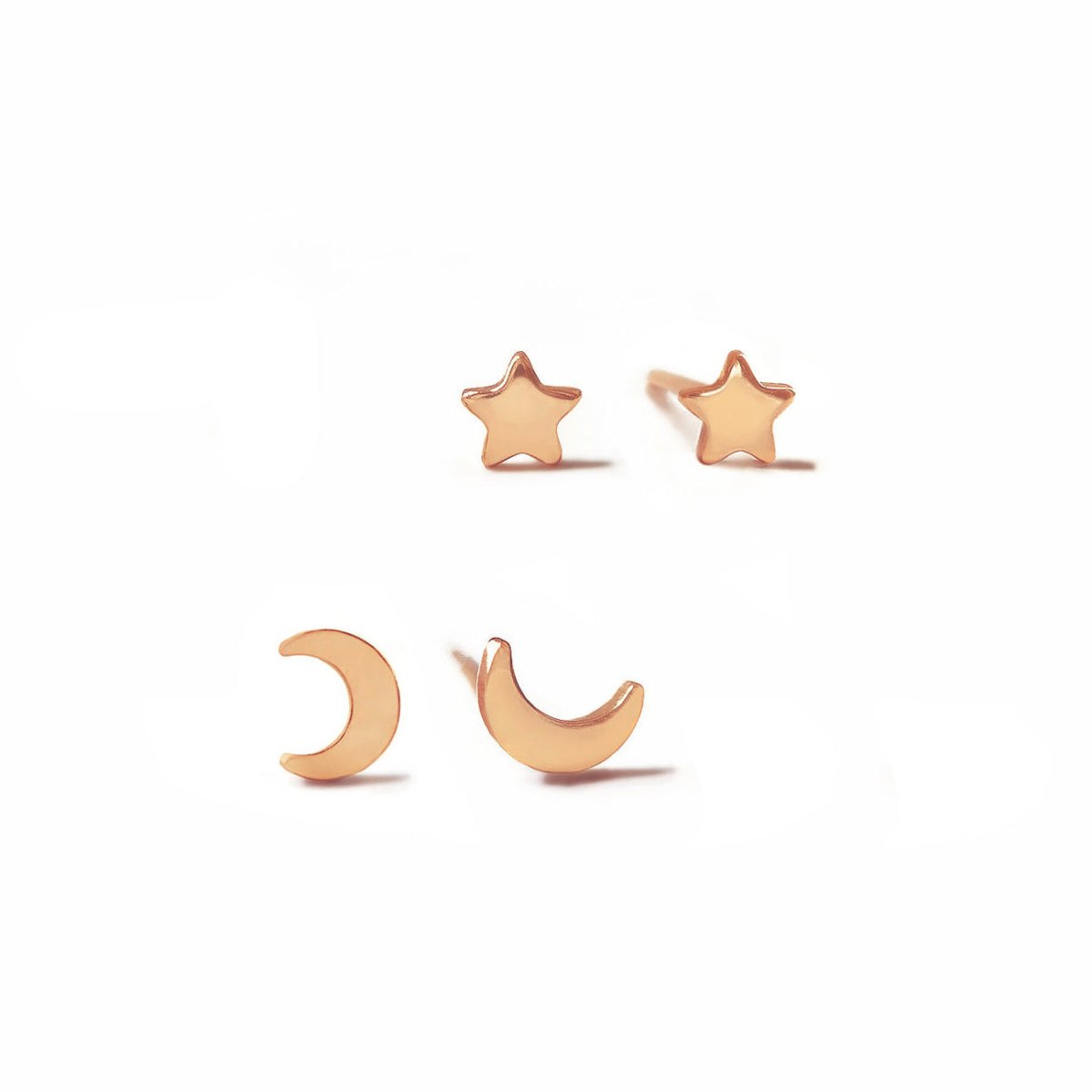 Rose gold vermeil tiny moon and star stud earrings with polished crescent and star shapes, on a white background
