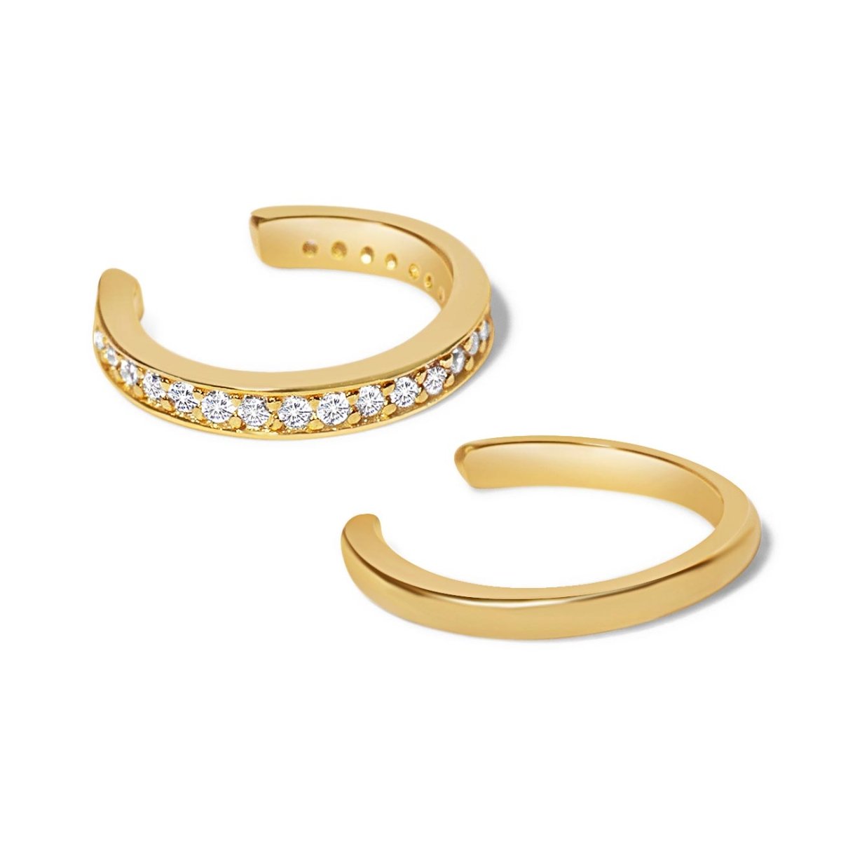 Gold vermeil ear cuff set, one pavé with clear stones and one plain band, on a white background
