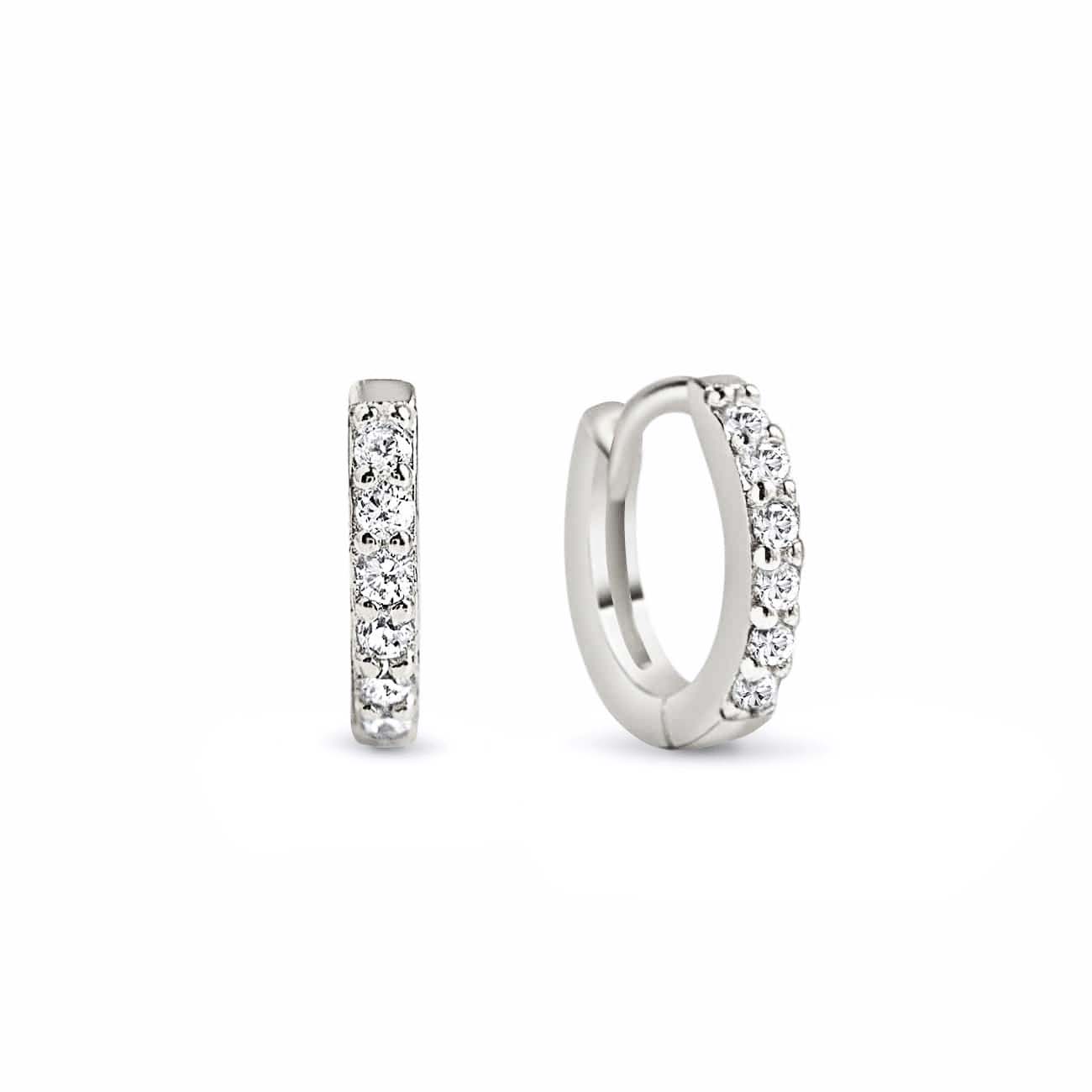 Sterling silver pavé huggie earrings lined with white zirconia, front and side view on a white background