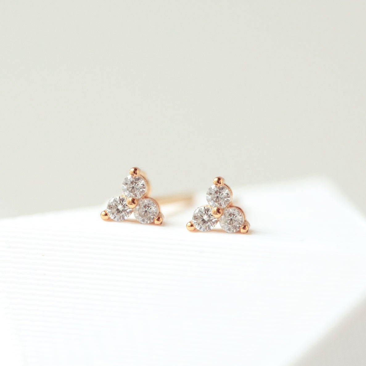 Close up of earring featuring Rose Gold Vermeil Clover Stud Earrings