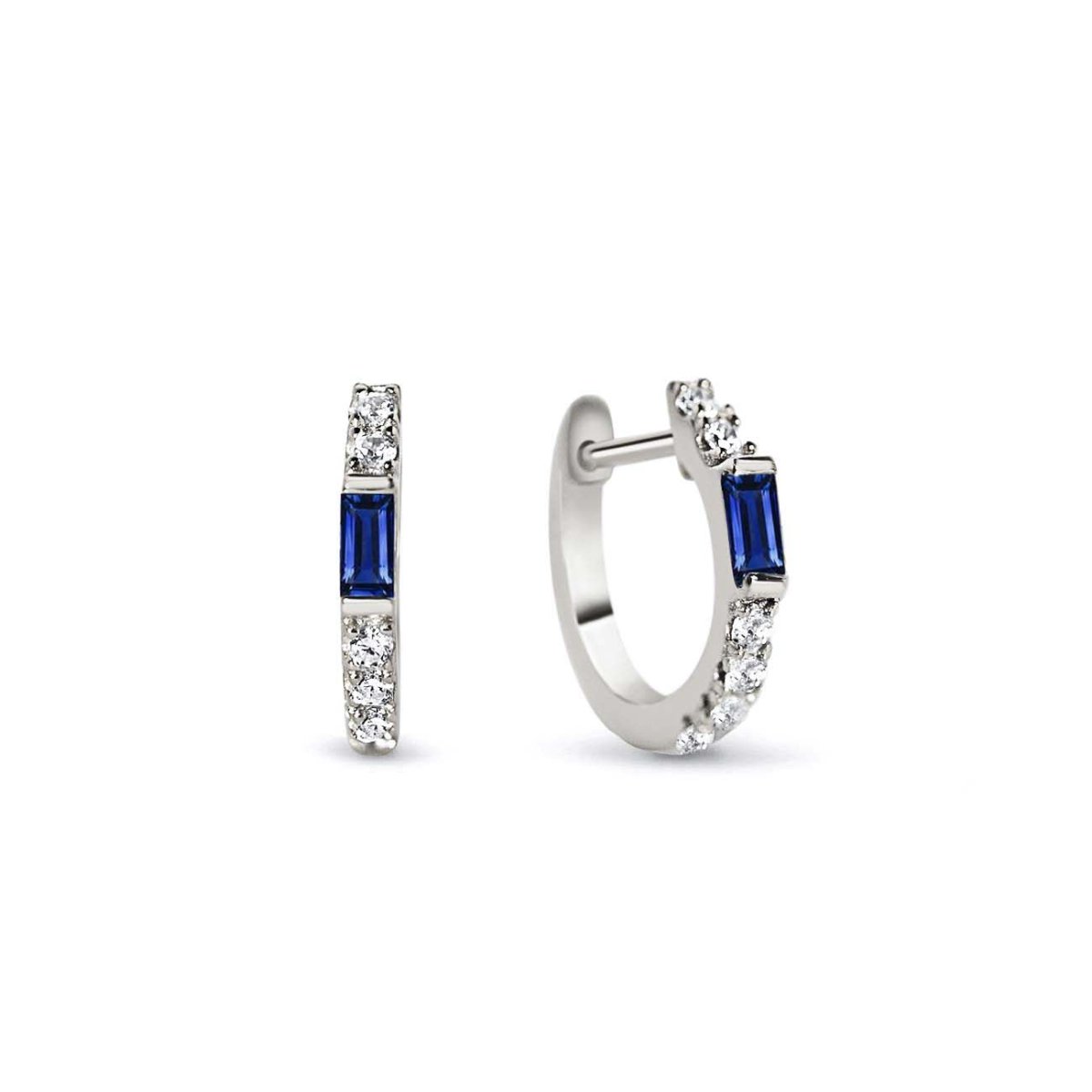 Sterling silver baguette huggie hoops with a blue sapphire baguette and white zirconia, on a white background