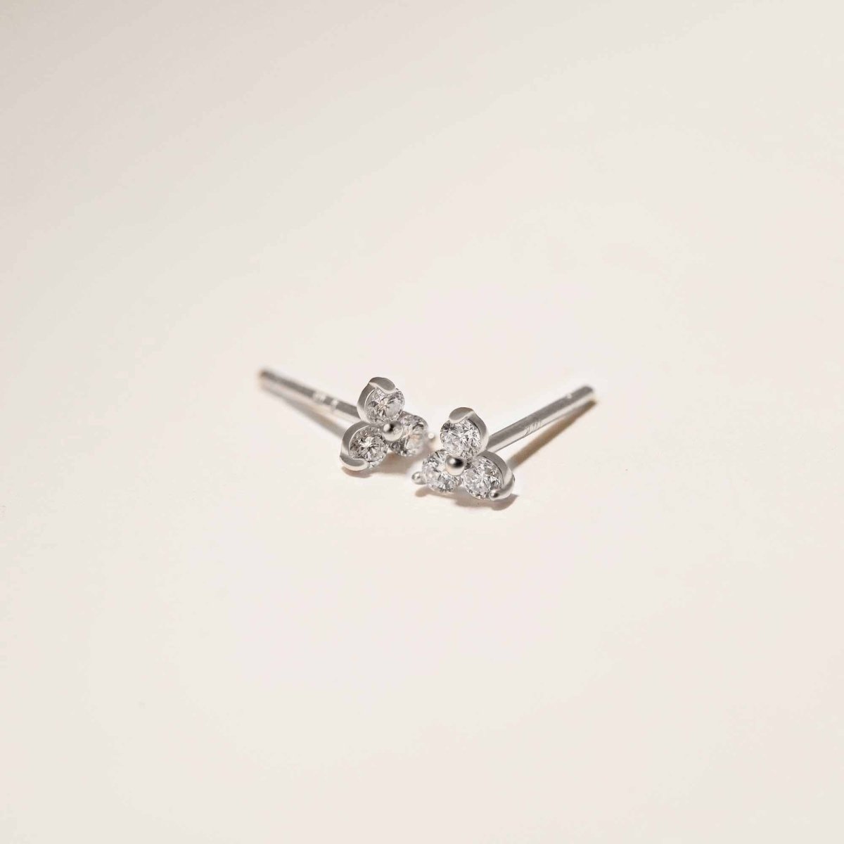 Close up of earrings featuring 14K White Gold Tiny Clover Pave Stud