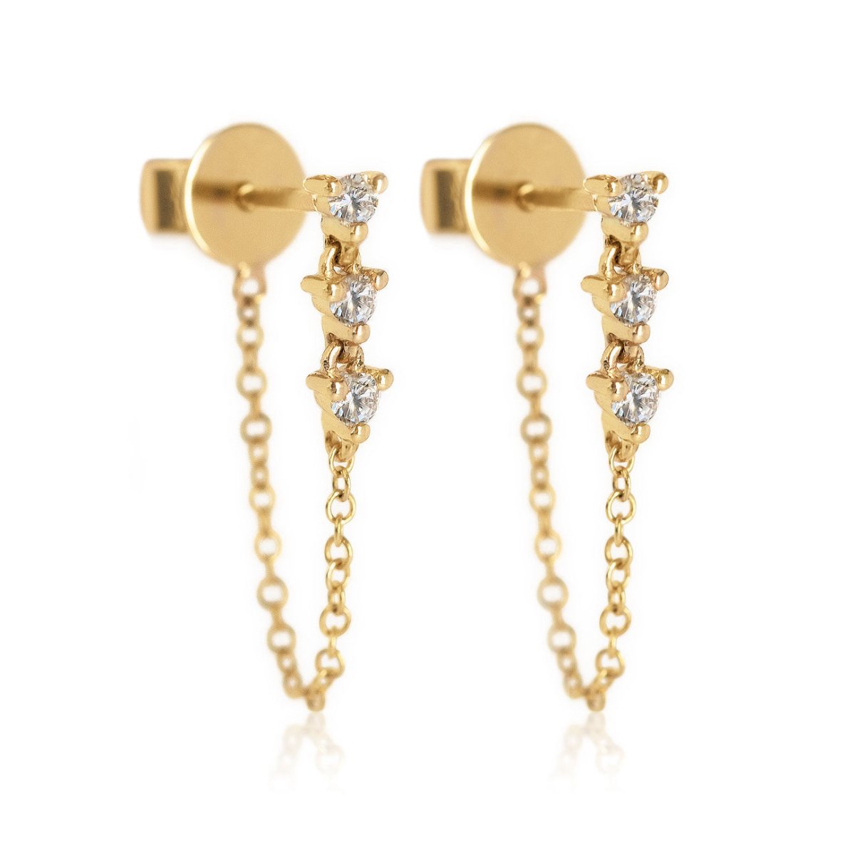 Pair of 14K gold diamond drop chain stud earrings with three round stones, on a white background
