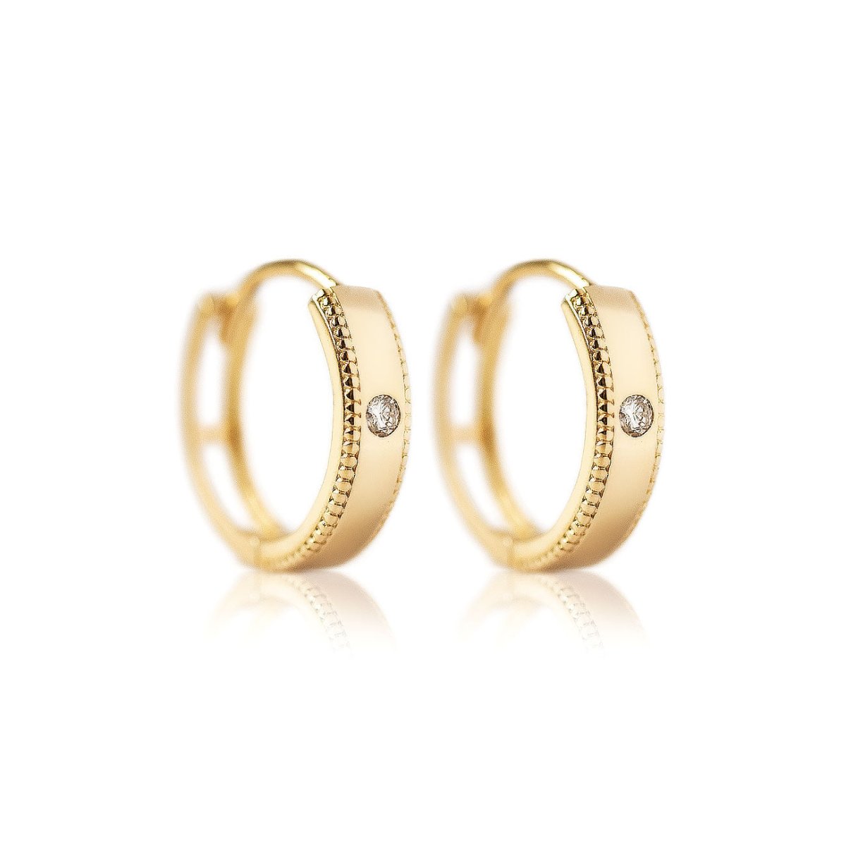 14K gold milgrain band huggie hoops with a central white sapphire, on a white background