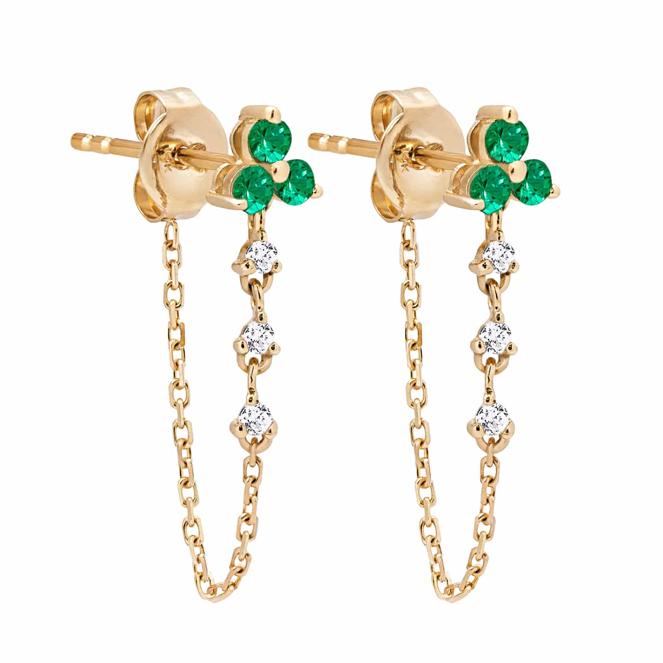 Pair of 14K gold chain earrings with a three-stone emerald cluster and dangling clear stones, on a white background