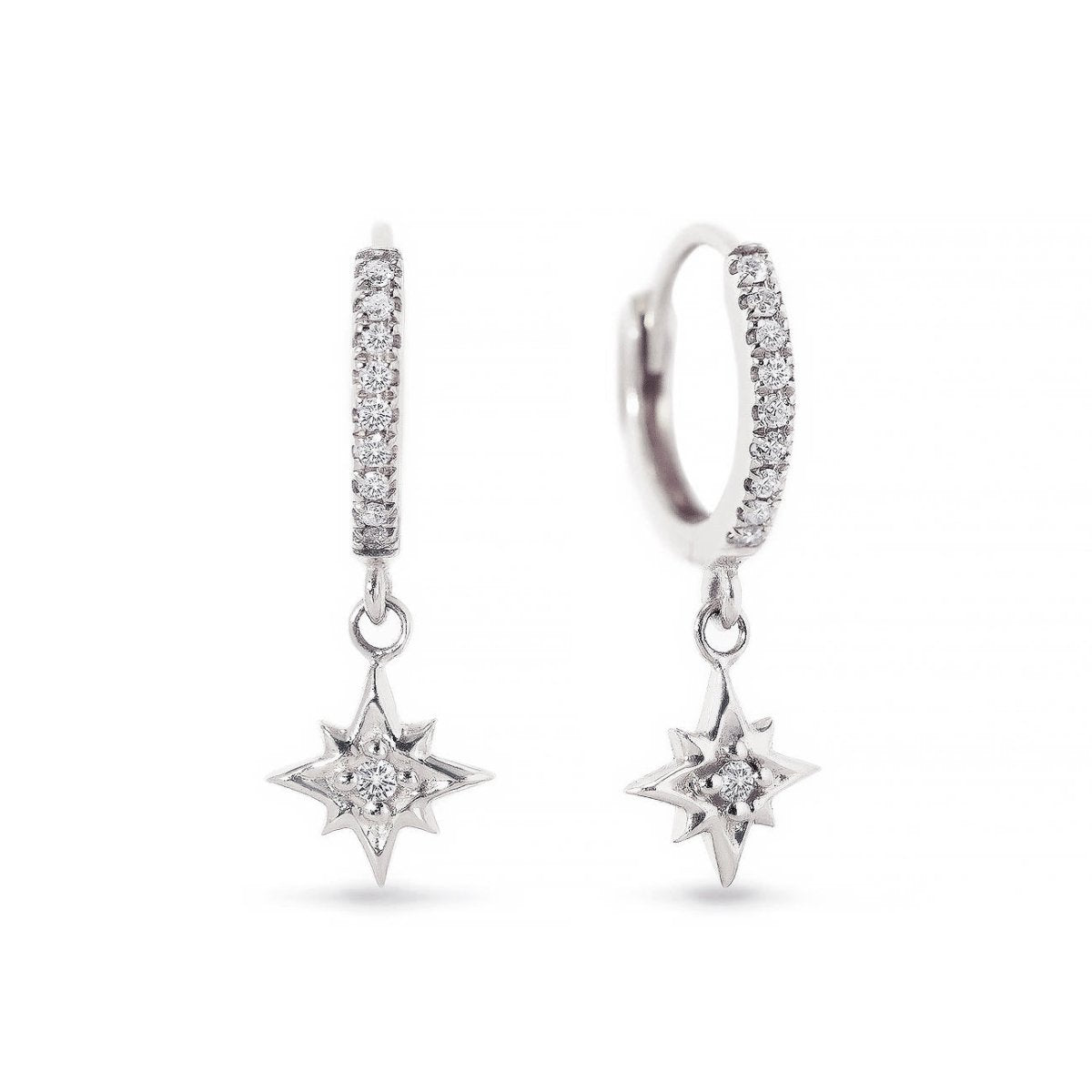 14K white gold pavé huggie hoops with a dangling diamond starburst charm, on a white background
