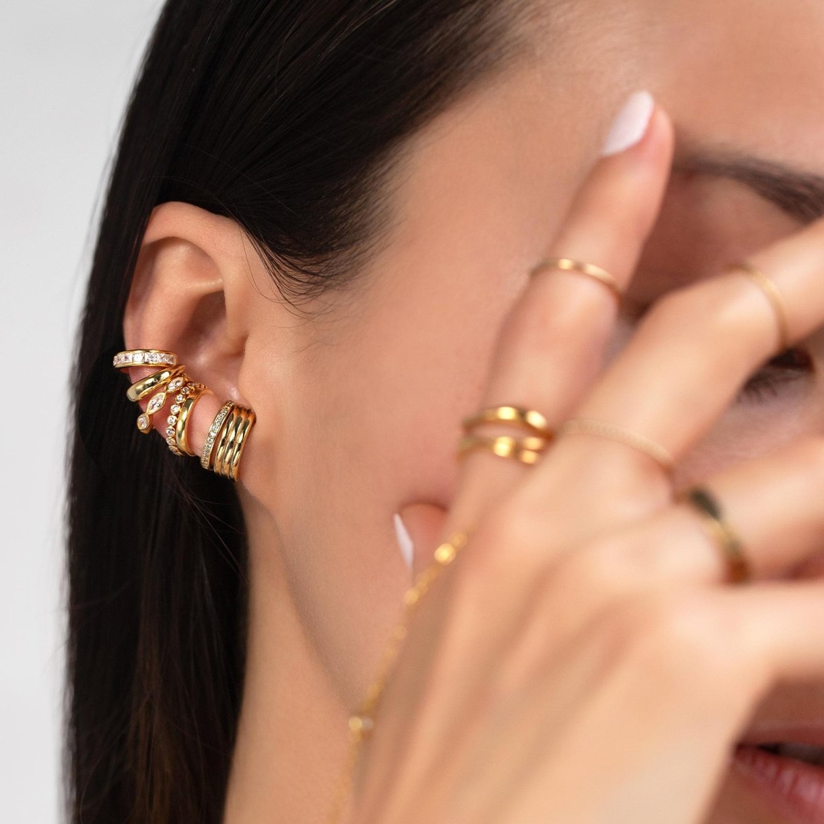 Gold vermeil pavé ear cuff with white zirconia, shown stacked on a model's ear