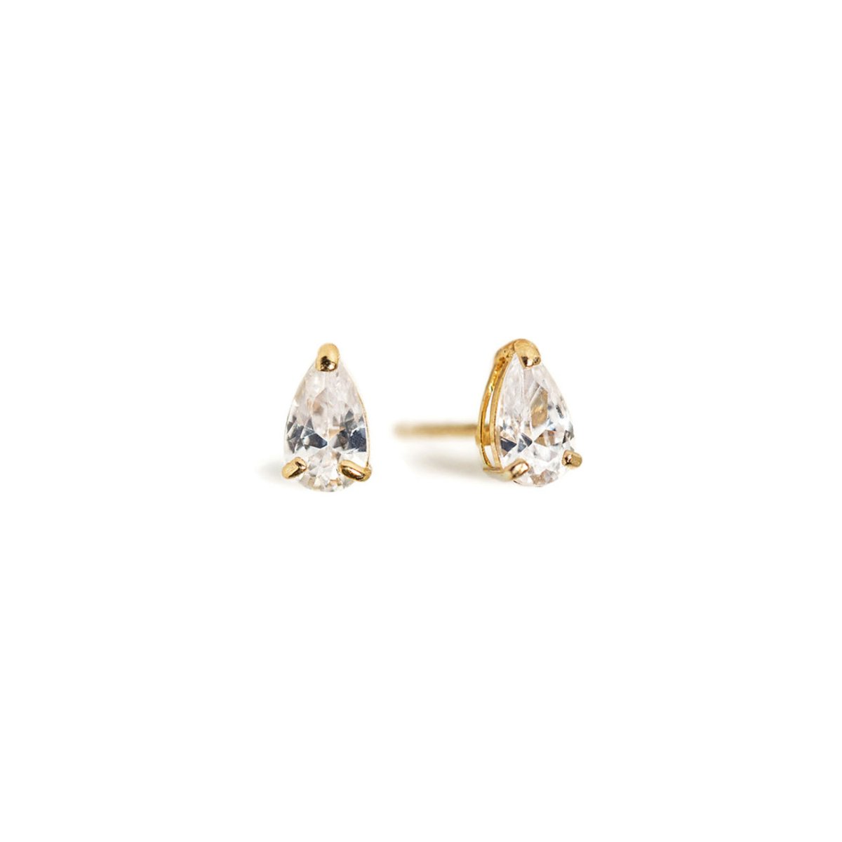 Pair of 14K gold pear stud earrings with clear teardrop stones, on a white background