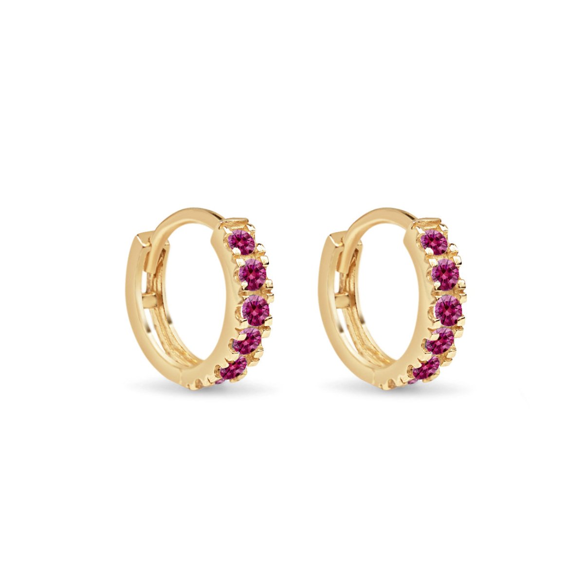 Pair of 14K gold pave huggie hoops set with red ruby stones, on a white background