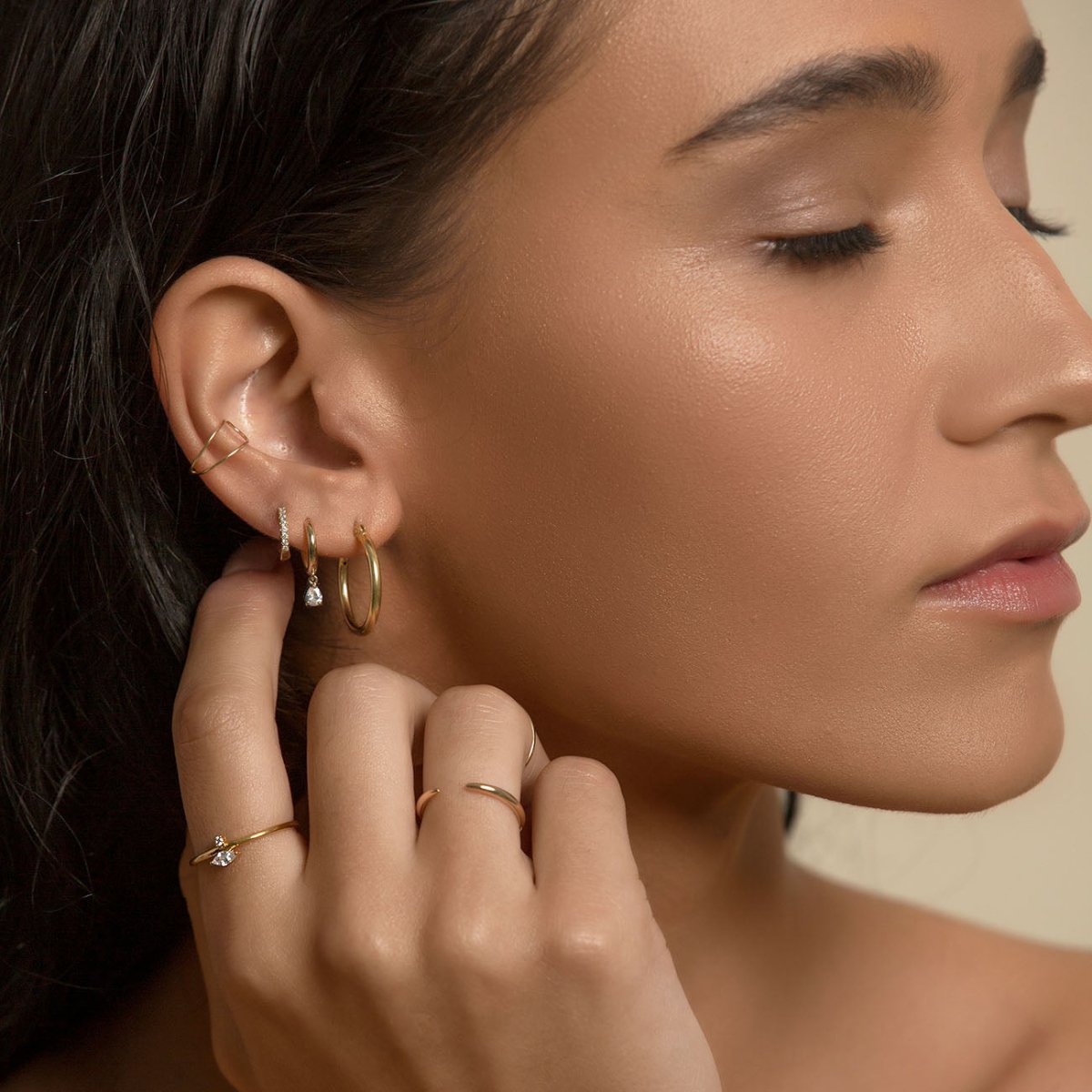 Gold vermeil thin claw ring shown on a model's hand near the face