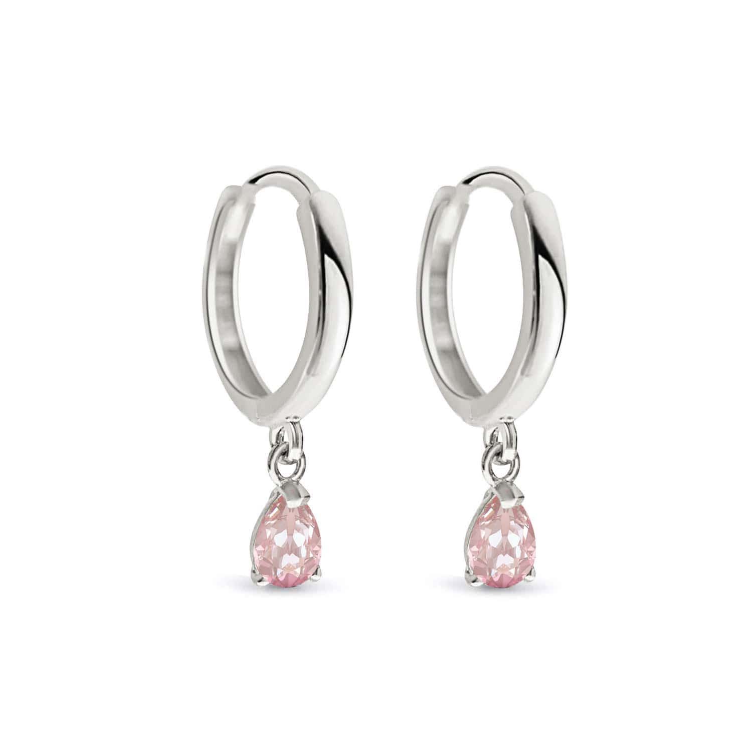 Pair of 14K white gold huggie hoops with pear-cut pink sapphire drops, on a white background